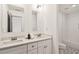 Bright bathroom featuring double vanity, granite countertops, and patterned floor at 2206 Loring Ct, Decatur, GA 30032