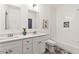 Elegant bathroom with double vanity, white cabinets, and a tub shower with unique tile accents at 2206 Loring Ct, Decatur, GA 30032