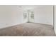 A spacious bedroom with neutral carpeting and plenty of natural light from two windows at 2206 Loring Ct, Decatur, GA 30032