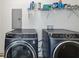 Laundry room featuring a modern washer and dryer, with storage shelving above at 2206 Loring Ct, Decatur, GA 30032