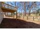 Spacious, fenced backyard with a wooden deck overlooking the yard from the raised main level at 3362 Alexis Ct, Marietta, GA 30066