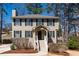 Charming two-story home featuring beige siding, black shutters, and a welcoming front porch with well-manicured landscaping at 3362 Alexis Ct, Marietta, GA 30066