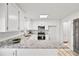 Modern kitchen featuring white cabinets, granite countertops, stainless steel appliances, and wood-look floors at 3362 Alexis Ct, Marietta, GA 30066