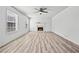 Bright living room with fireplace, ceiling fan, and large windows offering plenty of natural light on wood-look floors at 3362 Alexis Ct, Marietta, GA 30066