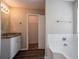 Bathroom with granite vanity top, a bathtub, and a door leading to a walk-in closet at 4096 Waldrop Hills Dr, Decatur, GA 30034