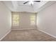 Neutral bedroom featuring a trey ceiling with fan, plush carpet, and natural light from two windows at 4096 Waldrop Hills Dr, Decatur, GA 30034