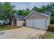 View of a single-story house, with a two-car garage and neutral vinyl siding, and a concrete driveway at 4096 Waldrop Hills Dr, Decatur, GA 30034