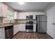 Beautiful kitchen with stainless steel appliances, granite countertops, white cabinetry, and dark-stained hardwood floors at 4096 Waldrop Hills Dr, Decatur, GA 30034