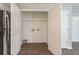 Open laundry room with stainless refrigerator and hardwood flooring at 4096 Waldrop Hills Dr, Decatur, GA 30034