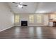 Inviting living room featuring vaulted ceilings, a cozy fireplace, large windows, and dark wood-look flooring at 4096 Waldrop Hills Dr, Decatur, GA 30034