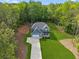Aerial view features home with mature trees, well-maintained lawn, and two-car garage for suburban comfort at 7031 Palomino Trl, Winston, GA 30187