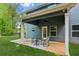 Cozy covered back patio featuring an outdoor ceiling fan and a comfortable seating area on the concrete slab at 7031 Palomino Trl, Winston, GA 30187