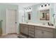 Bathroom featuring a double sink vanity with white countertops, grey cabinetry, and modern light fixtures at 7031 Palomino Trl, Winston, GA 30187