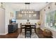 Dining room features modern light fixture, wainscoting, and open layout, perfect for meals and gatherings at 7031 Palomino Trl, Winston, GA 30187
