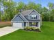 Beautifully landscaped two-story home with a spacious lawn and an attached two-car garage offers great curb appeal at 7031 Palomino Trl, Winston, GA 30187