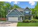 Charming two-story home boasts a well-maintained lawn, a two-car garage, and eye-catching curb appeal at 7031 Palomino Trl, Winston, GA 30187
