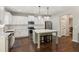 Modern kitchen features white cabinets, stainless appliances, and a center island with seating at 7031 Palomino Trl, Winston, GA 30187