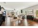 Open living room with hardwood floors, stone fireplace, and ample natural light from large windows at 7031 Palomino Trl, Winston, GA 30187