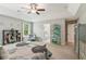 Spacious main bedroom featuring a tray ceiling, an ensuite bathroom entrance, and a gray accent color scheme at 7031 Palomino Trl, Winston, GA 30187