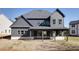 Back exterior of home with gray siding, covered porch, and large backyard at 750 Garden Reserve Ln, Alpharetta, GA 30005