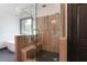 Shower boasts a wood-look design with pebble flooring, a glass door and a built in bench at 750 Garden Reserve Ln, Alpharetta, GA 30005