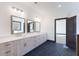 Bathroom featuring double sinks with granite countertops and wood cabinets at 750 Garden Reserve Ln, Alpharetta, GA 30005