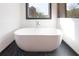 Bathroom with a freestanding tub and black marble floors at 750 Garden Reserve Ln, Alpharetta, GA 30005