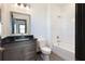 Well-lit bathroom with a gray vanity, framed mirror, and a shower-tub combo with white tiling at 750 Garden Reserve Ln, Alpharetta, GA 30005