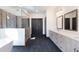 Modern bathroom with double vanity, freestanding tub, and a glass enclosed shower with wood look accents at 750 Garden Reserve Ln, Alpharetta, GA 30005