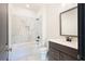 Modern bathroom featuring vanity, tile flooring, and a shower and tub with stylish white tile at 750 Garden Reserve Ln, Alpharetta, GA 30005