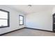 This bedroom is bright with white walls, light hardwood floors and black trim windows and baseboards at 750 Garden Reserve Ln, Alpharetta, GA 30005