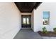 Inviting entryway with double glass doors, painted white brick walls, and a view to the interior of the home at 750 Garden Reserve Ln, Alpharetta, GA 30005