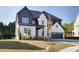 Charming home featuring a two-car garage, and well-maintained front yard at 750 Garden Reserve Ln, Alpharetta, GA 30005