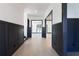 Spacious hallway with wainscoting, light hardwood floors, and open doorways to other rooms at 750 Garden Reserve Ln, Alpharetta, GA 30005