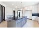 Open kitchen features a large gray island, stainless steel appliances, and storage space at 750 Garden Reserve Ln, Alpharetta, GA 30005