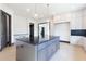 Spacious kitchen with a large island, custom cabinets, and modern lighting fixtures at 750 Garden Reserve Ln, Alpharetta, GA 30005