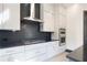 Contemporary kitchen includes white cabinets, subway tile backsplash, and stainless steel appliances at 750 Garden Reserve Ln, Alpharetta, GA 30005