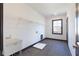 Bright laundry room featuring a utility sink, wire shelving, and tile flooring for functional convenience at 750 Garden Reserve Ln, Alpharetta, GA 30005