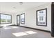 Bright living room featuring hardwood floors, large windows, and modern trim creating a comfortable and stylish space at 750 Garden Reserve Ln, Alpharetta, GA 30005