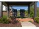 View of the community mailboxes under a pavilion, with stylish new homes visible in the background at 750 Garden Reserve Ln, Alpharetta, GA 30005