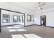 A spacious main bedroom featuring light hardwood floors, recessed lighting, a ceiling fan, and multiple windows at 750 Garden Reserve Ln, Alpharetta, GA 30005