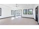 A spacious and bright main bedroom with a tray ceiling, light hardwood floors, and many windows for natural light at 750 Garden Reserve Ln, Alpharetta, GA 30005