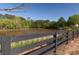 A fence surrounds a pond with a gazebo enhancing the property's appeal at 750 Garden Reserve Ln, Alpharetta, GA 30005