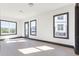 Bright and airy room with hardwood floors, large windows, and stylish black trim at 750 Garden Reserve Ln, Alpharetta, GA 30005