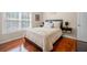 Bright bedroom with natural light, hardwood floors and neutral paint at 140 Lost Forest Dr, Mcdonough, GA 30252