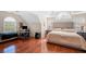 Spacious bedroom featuring a comfortable bed, hardwood floors, and two windows at 140 Lost Forest Dr, Mcdonough, GA 30252