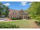 Charming two-story brick home with a well-manicured lawn and inviting front porch at 140 Lost Forest Dr, Mcdonough, GA 30252