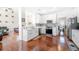 Bright kitchen with white cabinets, stainless steel appliances, and hardwood floors at 140 Lost Forest Dr, Mcdonough, GA 30252