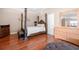 The main bedroom has a four-poster bed with warm hardwood floors at 140 Lost Forest Dr, Mcdonough, GA 30252