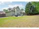 A house featuring a well-maintained lawn, patio, mature trees, and a fenced backyard at 4185 Cami Way, Buford, GA 30519